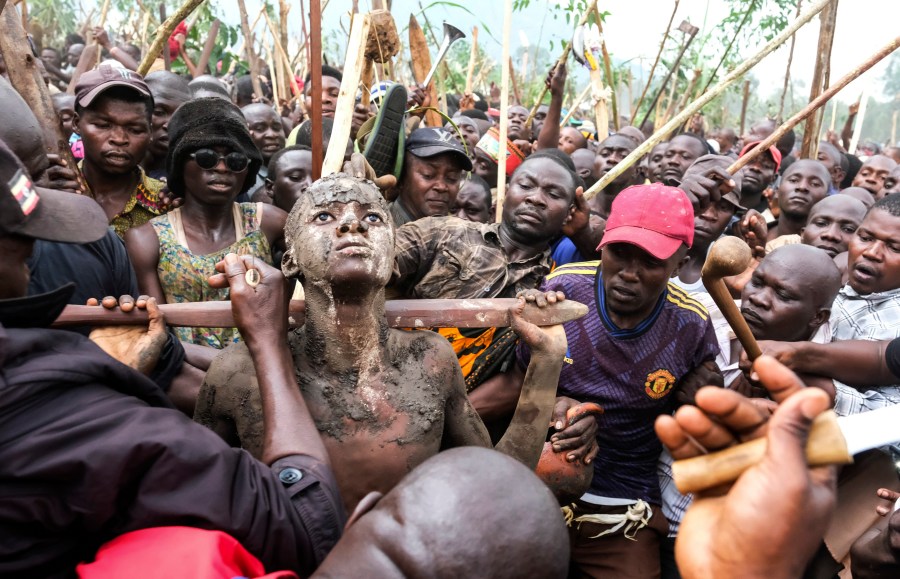 Daniel Wabuyi reacts during his traditional circumcision ritual, known as Imbalu, at Kamu village in Mbale, Eastern Uganda, Saturday, Aug. 3, 2024. (AP Photo/Hajarah Nalwadda)