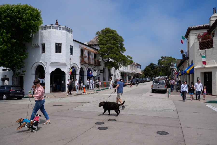 People visit Carmel-By-The-Sea, Calif., on Tuesday, July 23, 2024. (AP Photo/Godofredo A. Vásquez)