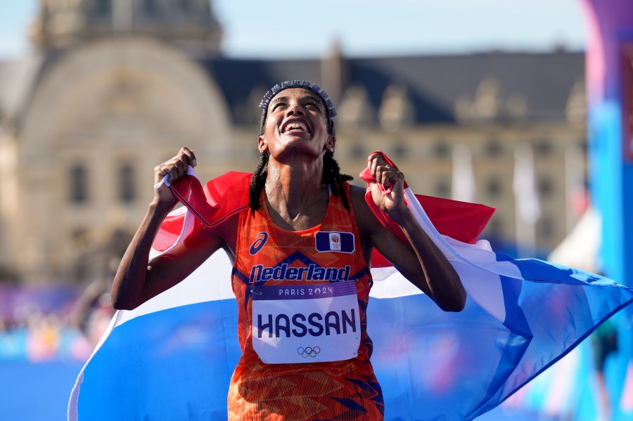 Sifan Hassan, of the Netherlands, celebrates after crossing the finish line to win the gold medal at the end of the women's marathon competition at the 2024 Summer Olympics, Sunday, Aug. 11, 2024, in Paris, France. (AP Photo/Vadim Ghirda)