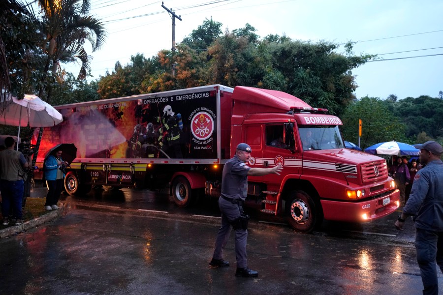 A military fire truck used to carry bodies leave at the gated community where a plane crashed in Vinhedo, Sao Paulo state, Brazil, Saturday, Aug. 10, 2024. (AP Photo/Andre Penner)