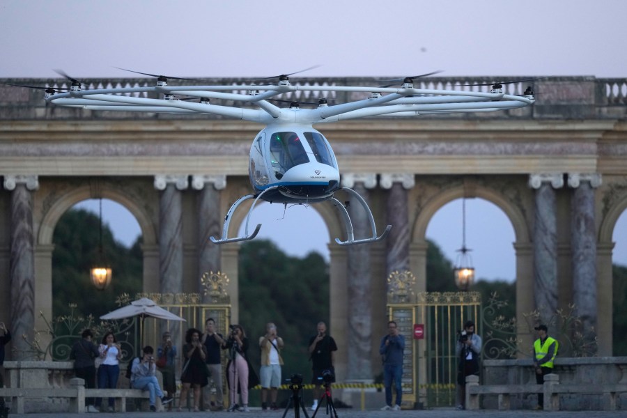 A Volocopter aircraft carries out a test flight on the last day of the 2024 Olympics with a sunrise demonstration at the 2024 Summer Olympics, Sunday, Aug. 11, 2024, in Versailles, France. (AP Photo/Mosa'ab Elshamy)