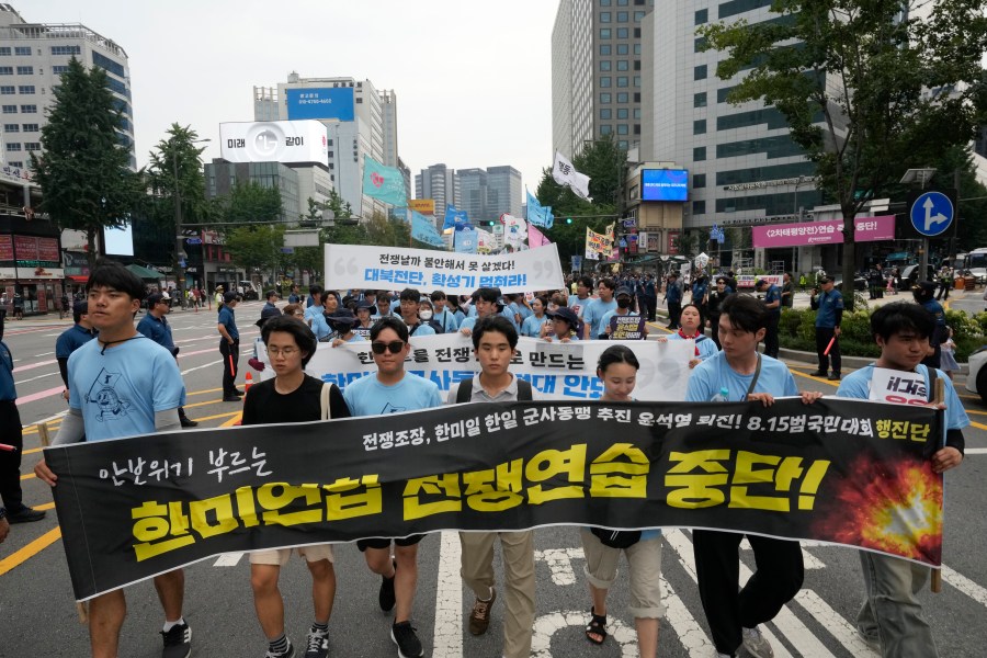 South Korean protesters march during a rally opposing the joint military exercises between the U.S. and South Korea in Seoul, South Korea, Saturday, Aug. 10, 2024. The banner reads "Stop the military exercises between the U.S. and South Korea."(AP Photo/Ahn Young-joon)