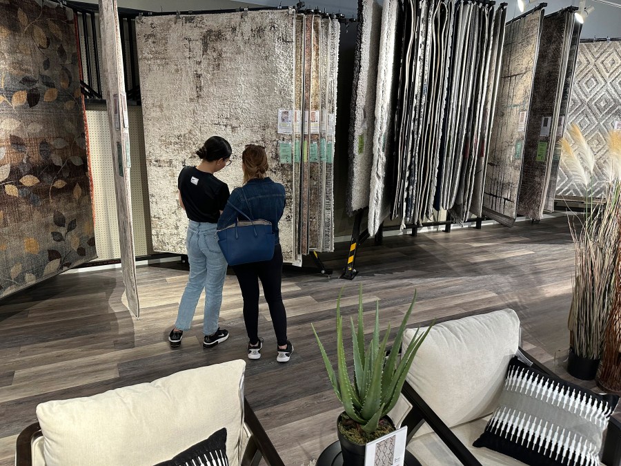 FILE - Shoppers consider rug samples on display in a furniture store June 2, 2024, in Lone Tree, Colo. (AP Photo/David Zalubowski, File)