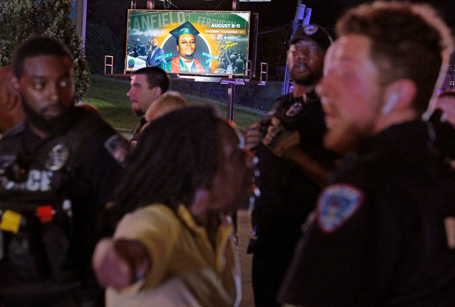 Protesters lash out verbally at Ferguson, Mo., police on Friday, Aug. 9, 2024, after protests turned to turmoil with a couple of arrests outside the police department on the 10th anniversary of Michael Brown's death at a gathering of several of the original protesters. (Christian Gooden//St. Louis Post-Dispatch via AP)