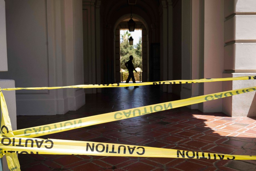 A man walks past caution tape through Pasadena City Hall on Monday, Aug. 12, 2024, in Pasadena, Calif, after an earthquake was strongly felt from the Los Angeles area all the way to San Diego. (Sarah Reingewirtz/The Orange County Register via AP)