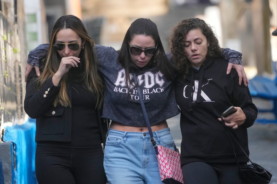 Friends and relatives of Danilo Santos Romano leave Penha Cemetery after his burial in Sao Paulo, Brazil, Monday, Aug. 12, 2024. Romano was the pilot of the plane that crashed into the backyard of a home in the city of Vinhedo on Aug. 9. (AP Photo/Andre Penner)