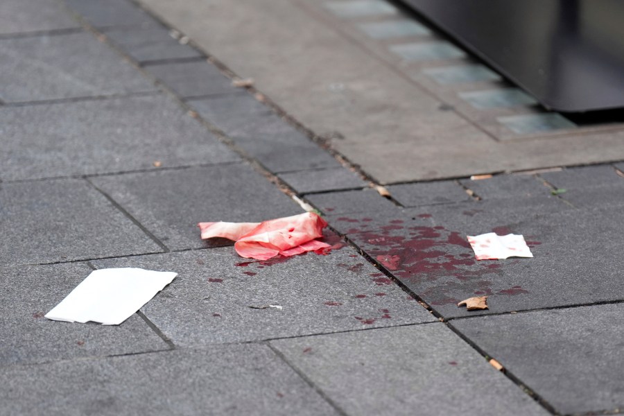 Blood is seen on the pavement as a man has been arrested after an 11-year-old girl and 34-year-old woman were stabbed in Leicester Square, in London, Monday Aug. 12, 2024. (James Manning/PA via AP)