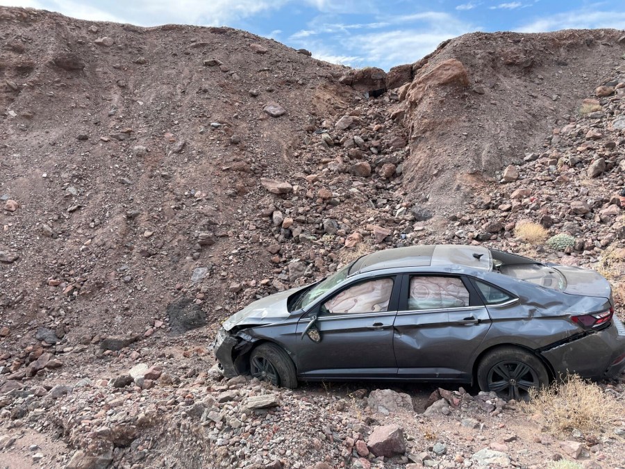 This image provided by the National Park Service shows a car owned by Peter Hayes Robino of Duarte, who drove off a 20-foot embankment at the edge of the parking lot at Death Valley National Park, on Aug. 1, 2024, and died of hyperthermia, or overheating. (National Park Service via AP)