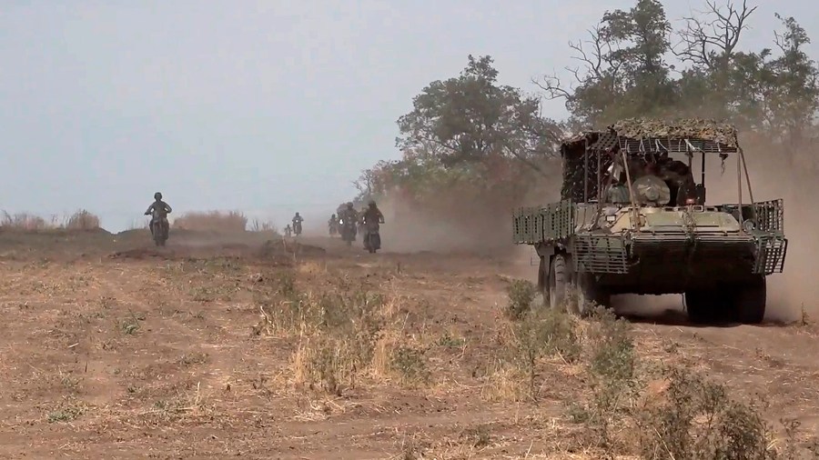 In this photo taken from video released by Russian Defense Ministry Press Service on Monday, Aug. 12, 2024, marine assault team members ride an APC and motorcycles toward Ukrainian position at an undisclosed location. (Russian Defense Ministry Press Service photo via AP)