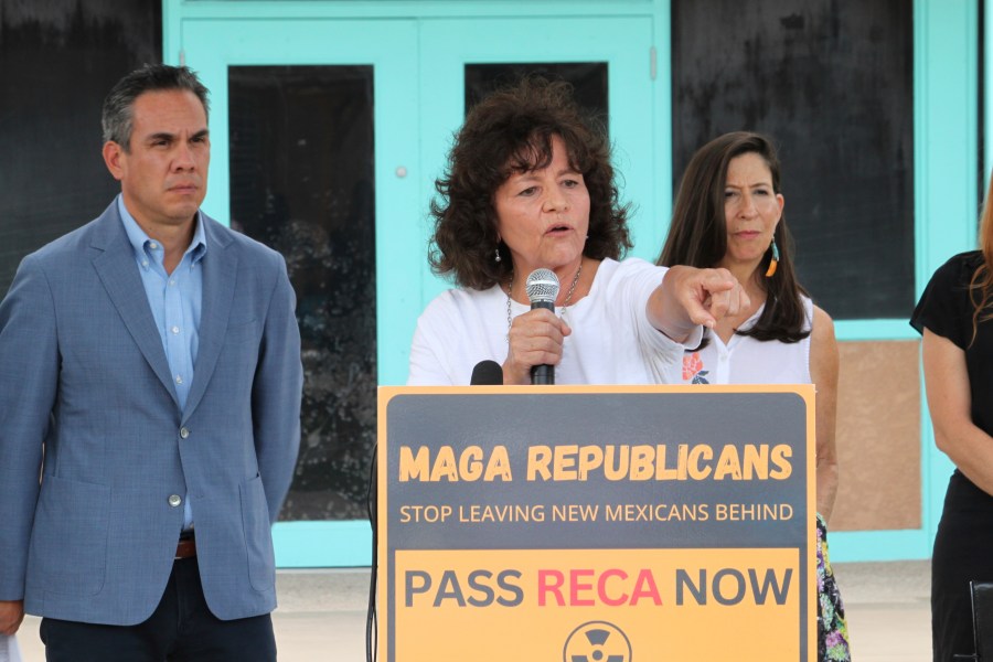 Tina Cordova, center, co-founder of the Tularosa Basin Downwinders Consortium, points to audience members who have been dealing with the consequences of radiation exposure, while politicians gathered for a news conference in Albuquerque, N.M., Tuesday, Aug. 13, 2024. (AP Photo/Susan Montoya Bryan)