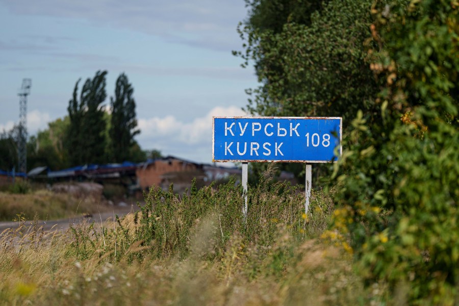 A plate with sign "Kursk 108 km" is seen on the Russian-Ukrainian border in Sumy region, Ukraine, Tuesday, Aug. 13, 2024. (AP Photo/Evgeniy Maloletka)