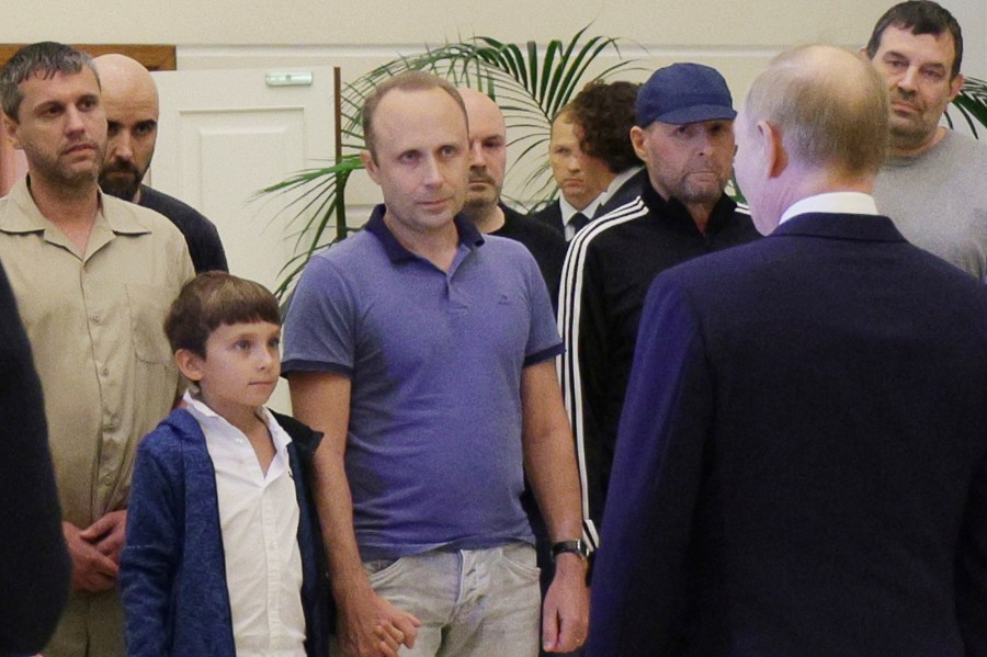 A man identified as Pablo González, a freelance journalist from Spain who had been based in Poland since 2019, second from left with shaved head, listens to Russian President Vladimir Putin, back to a camera, speaking to released Russian prisoners, part of the biggest prisoner swap between the United States and Russia in post-Soviet history, upon their arrival at the Vnukovo government airport outside Moscow, Russia, on Thursday, Aug. 1, 2024. Gonzalez had another passport and another name: Pavel Rubtsov. (Gavriil Grigorov, Sputnik, Kremlin Pool Photo via AP)