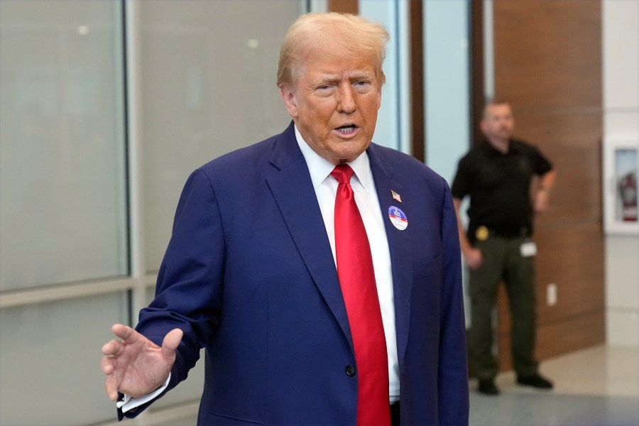 Republican presidential nominee former President Donald Trump talks at the Palm Beach County Supervisor of Elections, Wednesday, Aug. 14, 2024, in West Palm Beach, Fla., after he voted early in person in the Florida primary. (AP Photo/Wilfredo Lee)