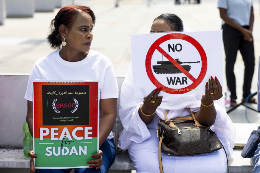 Demonstrators hold signs during a rally, on the opening day of peace talks for Sudan, at the Place des Nations in front of the European headquarters of the United Nations in Geneva, Switzerland, Wednesday, Aug. 14, 2024. (Salvatore Di Nolfi/Keystone via AP)