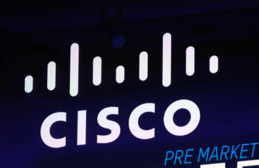 FILE - The Cisco logo appears on a screen at the Nasdaq MarketSite on Oct. 3, 2018 in New York's Times Square. (AP Photo/Richard Drew, File)