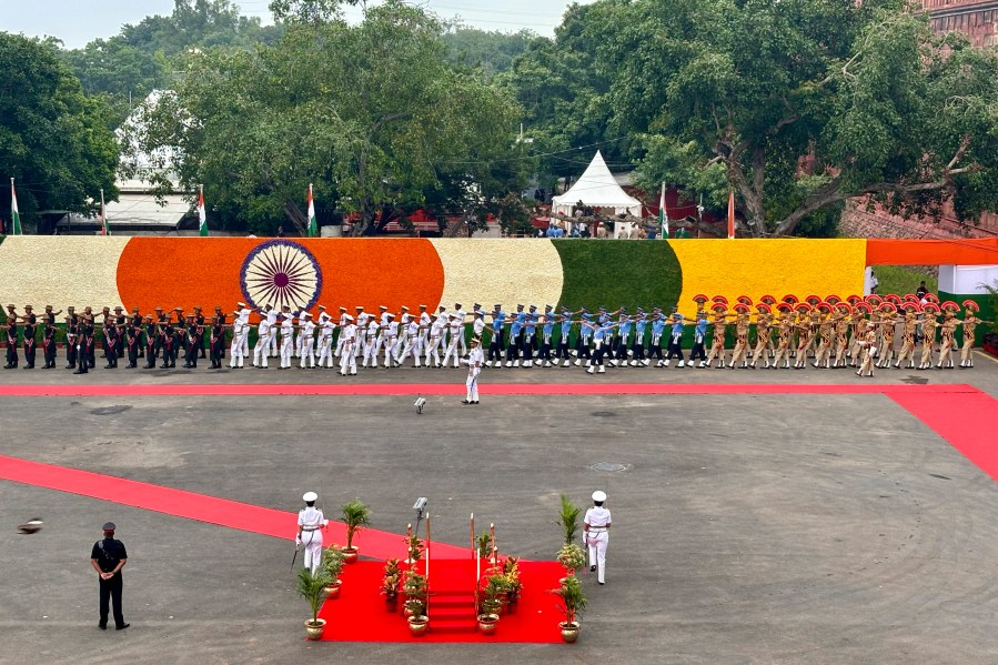 A joint contingent of Indian army, air force and navy march in to present guard of honor to Indian Prime Minister Narendra Modi before his arrival at the 17th century Mughal-era Red Fort monument for the country's Independence Day celebrations in New Delhi, India, Thursday, Aug. 15, 2024. (AP Photo/Manish Swarup)