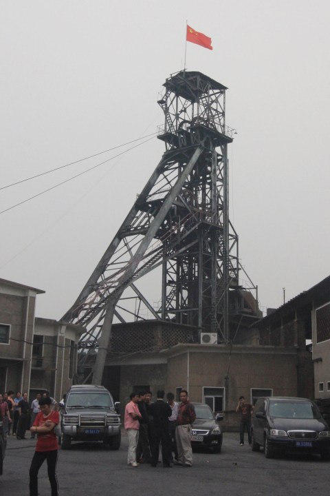 The Chinese flag is seen on a tower at a antimony mining company in Lengshuijiang in south China's Hunan province on Oct. 8, 2009. (Chinatopix via AP, File)