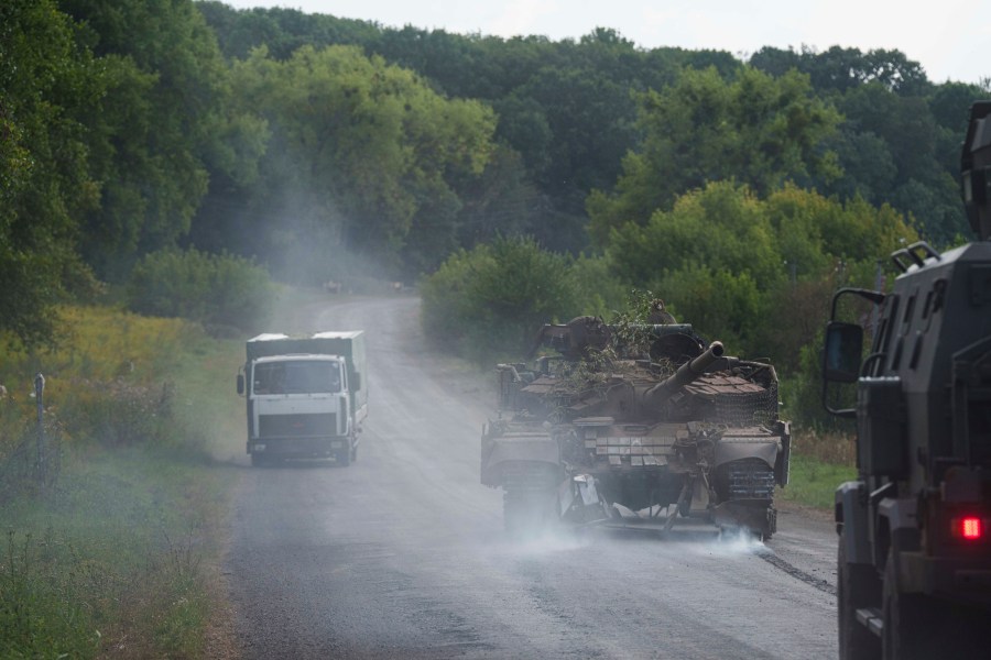 A damaged Ukrainian tank returns from Russia near the Russian-Ukrainian border in Sumy region, Ukraine, Thursday, Aug. 15, 2024. (AP Photo/Evgeniy Maloletka)