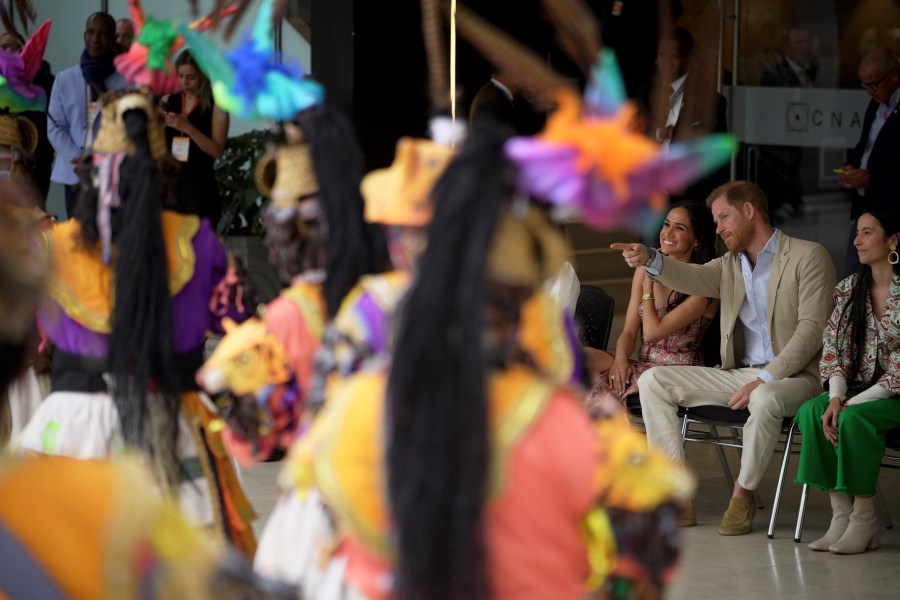 Prince Harry and Meghan attend a welcoming ceremony, at the Delia Zapata National Arts Center, accompanied by director Xiomara Suescun, right, in Bogota, Colombia, Thursday, Aug. 15, 2024. (AP Photo/Ivan Valencia)