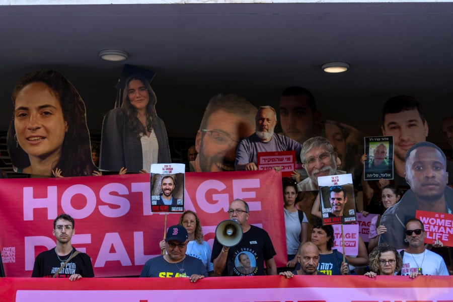 Relatives and supporters of Israeli hostages held by Hamas in Gaza hold photos of their loved ones during a protest calling for their return in Tel Aviv, Israel, Thursday, Aug. 15, 2024. (AP Photo/Ariel Schalit)