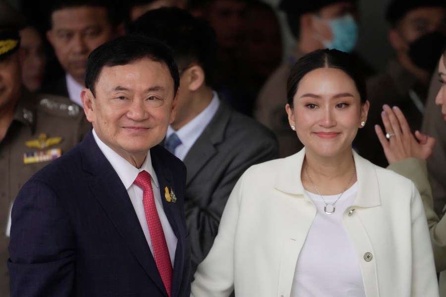 FILE - Thailand's former Prime Minister Thaksin Shinawatra, left, with, his daughter Paetongtarn, arrives at Don Muang airport in Bangkok, Thailand, Tuesday, Aug. 22, 2023.(AP Photo/Sakchai Lalit, File)