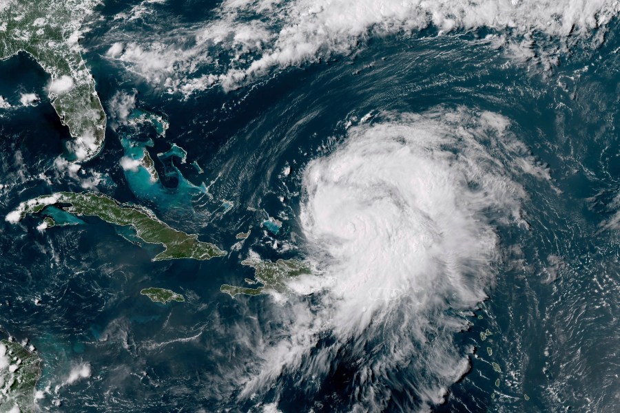 This GOES-16 GeoColor satellite image taken at 4 p.m EDT and provided by National Oceanic and Atmospheric Administration (NOAA) shows Hurricane Ernesto northwest of San Juan, Puerto Rico and moving over open waters, Wednesday, Aug. 14, 2024. (NOAA via AP)