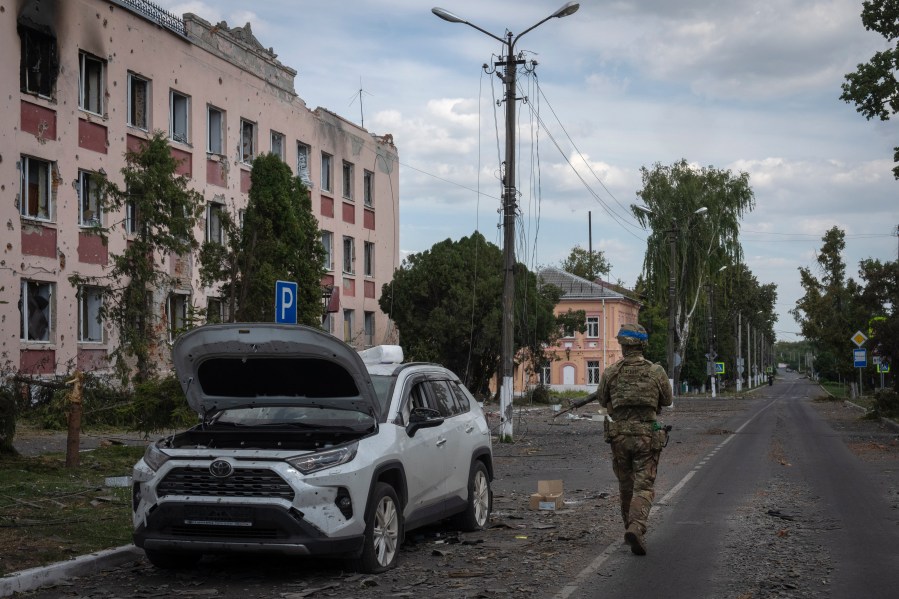 A Ukrainian soldier walks past at a city hall in Sudzha, Kursk region, Russia, Friday, Aug. 16, 2024. This image was approved by the Ukrainian Defense Ministry before publication. (AP Photo)