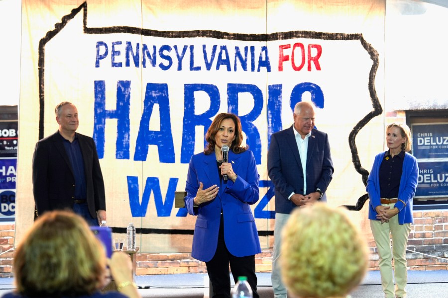 Democratic presidential nominee Vice President Kamala Harris speaks as second gentleman Doug Emhoff, from left, Democratic vice presidential nominee Minnesota Gov. Tim Walz and his wife Gwen Walz listen at a campaign event, Sunday, Aug. 18, 2024, in Rochester, Pa. (AP Photo/Julia Nikhinson)