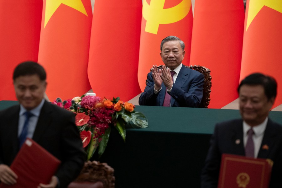 Vietnam's President To Lam, center, applauds during a signing ceremony at the Great Hall of the People in Beijing Monday, Aug. 19, 2024. (Andres Martinez Casares/Pool Photo via AP)