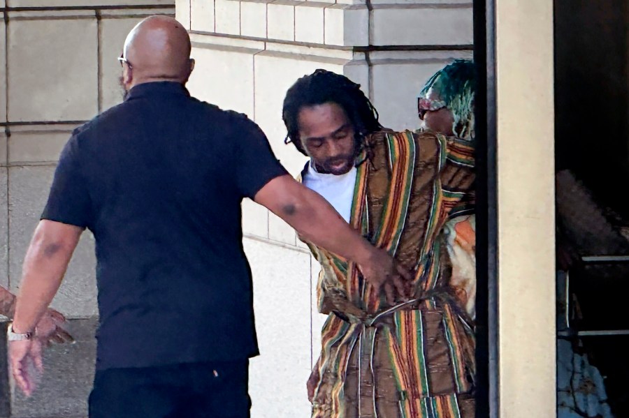 District of Columbia Councilman Trayon White, Sr., center, walks out of the federal courthouse after his initial appearance, Monday, Aug. 19, 2024 in Washington. White was arrested on a federal bribery charge by the FBI on Sunday. (AP Photo/Michael Kunzelman)