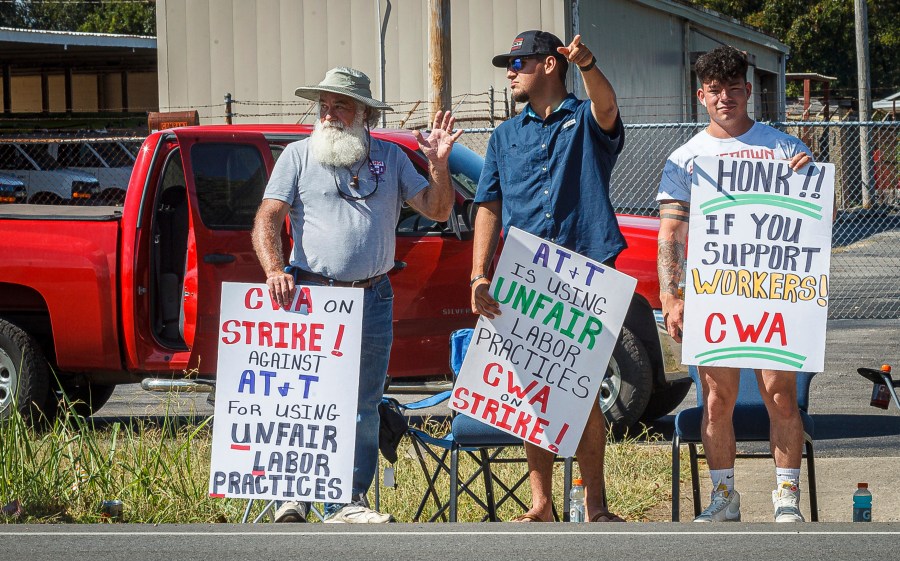 Kenny Yarbrough, President of the CWA Local 3911, left, joins other AT&T workers as they picket outside an AT&T warehouse on Cox Boulevard in Sheffield, Ala., on Monday, Aug. 19, 2024. (Dan Busey/The TimesDaily via AP)