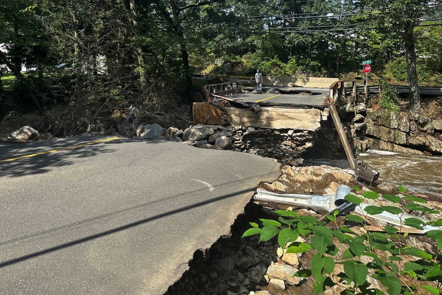 A bridge washed out on Seth Den Road in Oxford, Conn. after torrential rains turned streets into raging rivers in parts of Connecticut and New York's Long Island, trapping people in cars and a restaurant, covering vehicles in mud, and sweeping two women to their deaths, authorities said, Monday, Aug 19, 2024. (AP Photo Dave Collins)