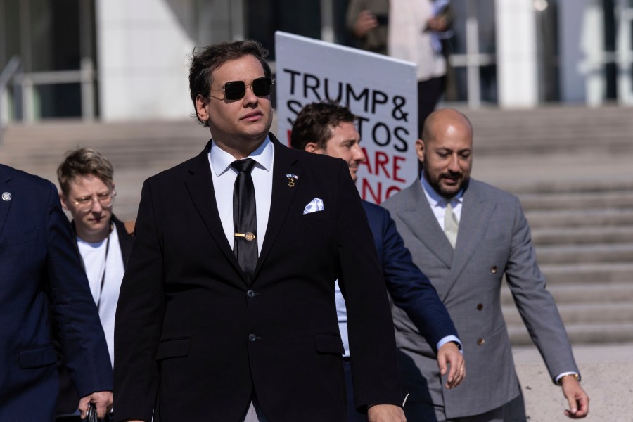 Former U.S. Rep George Santos leaves the federal courthouse with his lawyers in Central Islip, N.Y. on, Monday, Aug., 19, 2024. (AP Photo/Stefan Jeremiah)