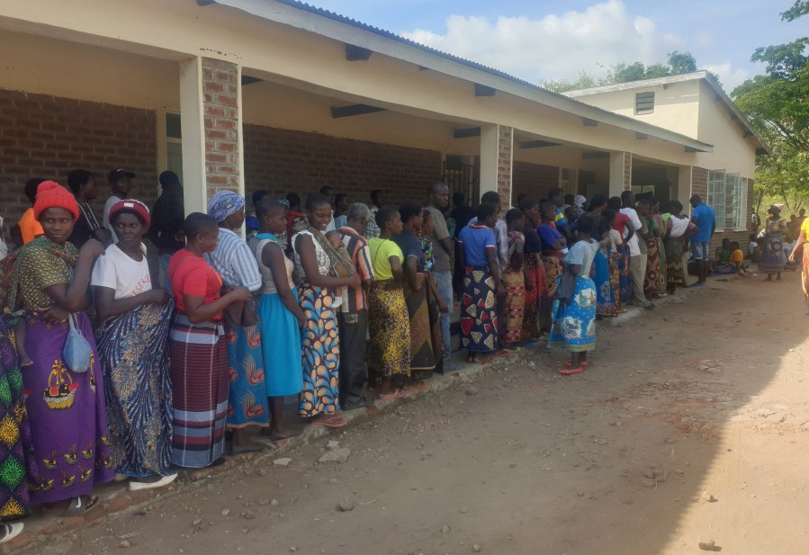 FILE - People queue for food at a World Food Programme distribution center in Neno district southern Malawi, March 24, 2024. (AP Photo/Kenneth Jali, file)