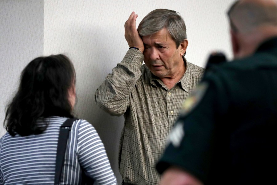 Antonios Pagourtzis, center, wipes away tears next to his wife, Rose Marie Kosmetatos, left, after a jury decided that they do not bear financial responsibility for the 2018 shooting at Santa Fe High School, Monday, Aug. 19, 2024, at the Galveston County Courthouse in Galveston, Texas. (Jennifer Reynolds/The Galveston County Daily News via AP, Pool)