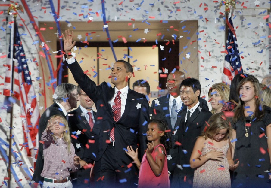 FILE - Democratic presidential candidate Sen. Barack Obama, D-Ill., waves with his family and his running mate's family after his acceptance speech at the Democratic National Convention at Invesco Field at Mile High in Denver, Aug. 28, 2008.(AP Photo/Alex Brandon, File)