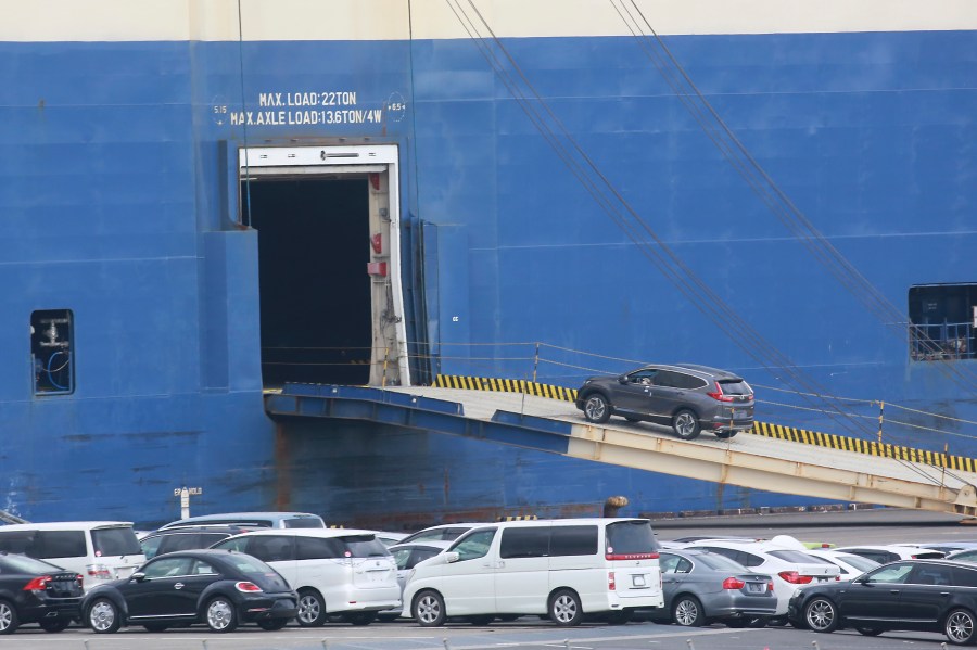 FILE - Cars for export are loaded onto a cargo ship at a port in Yokohama, near Tokyo on Nov. 2, 2021. (AP Photo/Koji Sasahara, File)