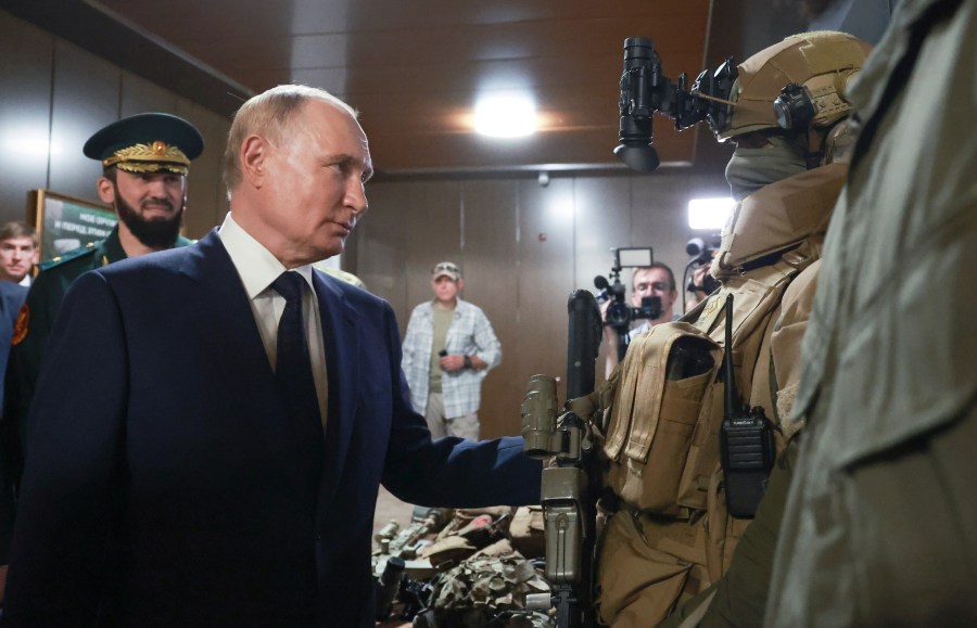 Russian President Vladimir Putin, accompanied by Prime Minister of the Chechen Republic Magomed Daudov, inspects Russian weapons and equipment during his visit to the Russian Special Forces University in Gudermes, Chechen Republic, Russia, Tuesday, Aug. 20, 2024. (Vyacheslav Prokofyev, Sputnik, Kremlin Pool Photo via AP)