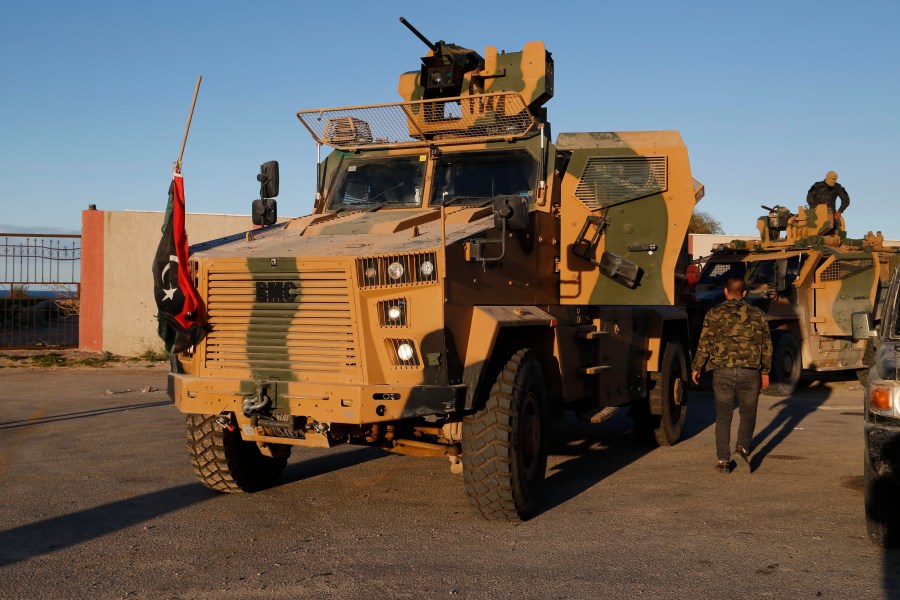 FILE - Forces loyal to the UN appointed interim prime minister Abdul Hamid Dbeibah arrive from Misrata to Tripoli in show of support Saturday, Feb. 12, 2022. (AP Photo/Yousef Murad, File)