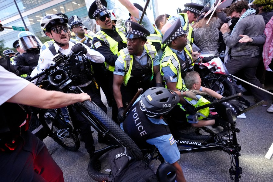 Demonstrators clash with police near the Israeli Consulate during the Democratic National Convention Tuesday, Aug. 20, 2024, in Chicago. (AP Photo/Alex Brandon)