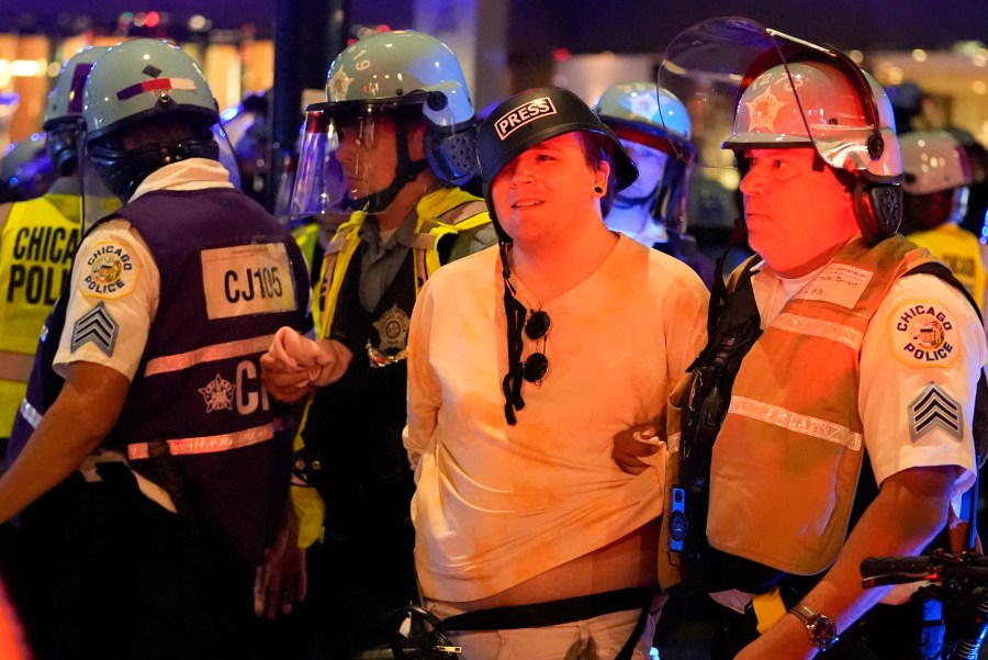 A demonstrators is taken into custody by police near the Israeli Consulate during the Democratic National Convention Tuesday, Aug. 20, 2024, in Chicago. (AP Photo/Julio Cortez)