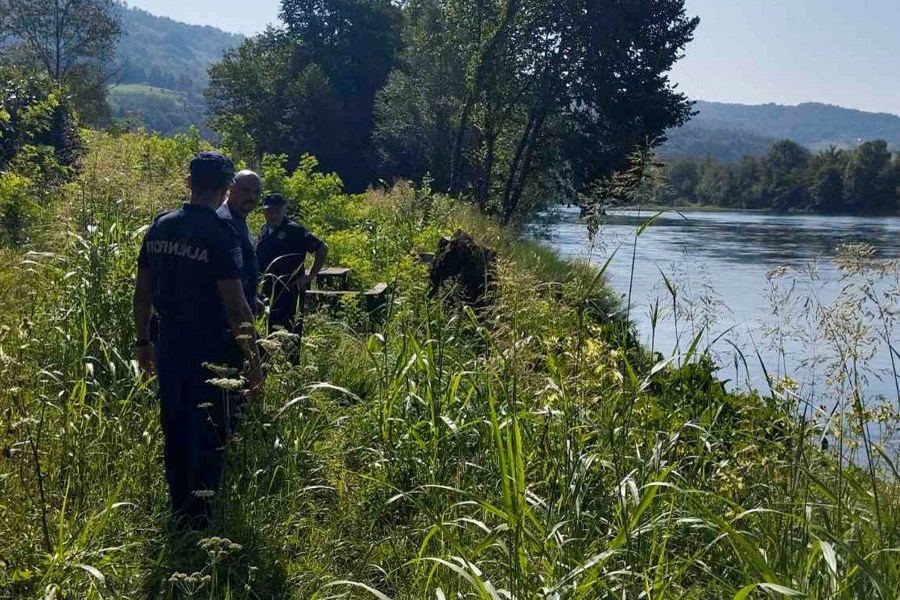 In this photograph made available by the Serbian Ministry of Interior, Serbian Police officers search a bank of the Drina River near the town of Ljubovija, Serbia, Thursday, Aug. 22, 2024. (Serbian Ministry of Interior via AP)