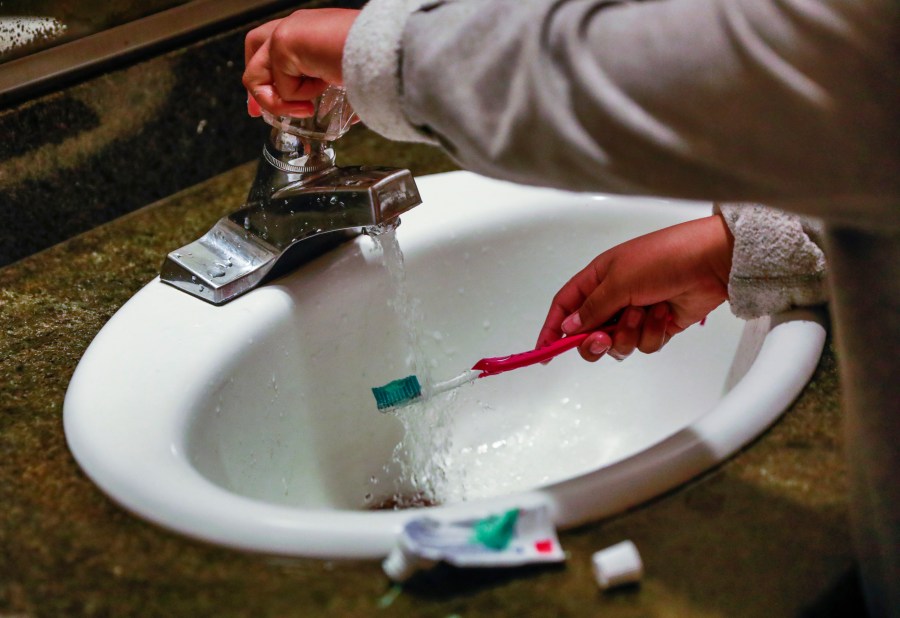 FILE - A child rinses a toothbrush in San Francisco on June 18, 2019. (Gabrielle Lurie/San Francisco Chronicle via AP, File)