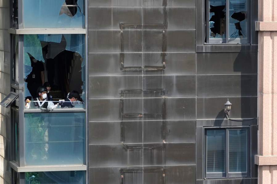 Members of a joint investigation team investigate at the site of a hotel burnt by Thursday's fire in Bucheon, South Korea, Friday, Aug. 23, 2024. (AP Photo/Ahn Young-joon)