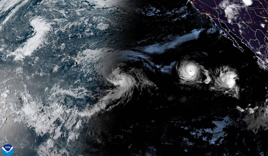 This satellite image provided by the National Oceanic and Atmospheric Administration (NOAA) shows Tropical Storm Hone and Hurricane Gilma located southeast of Hawaii, Thursday, Aug. 22, 2024. (NOAA via AP)