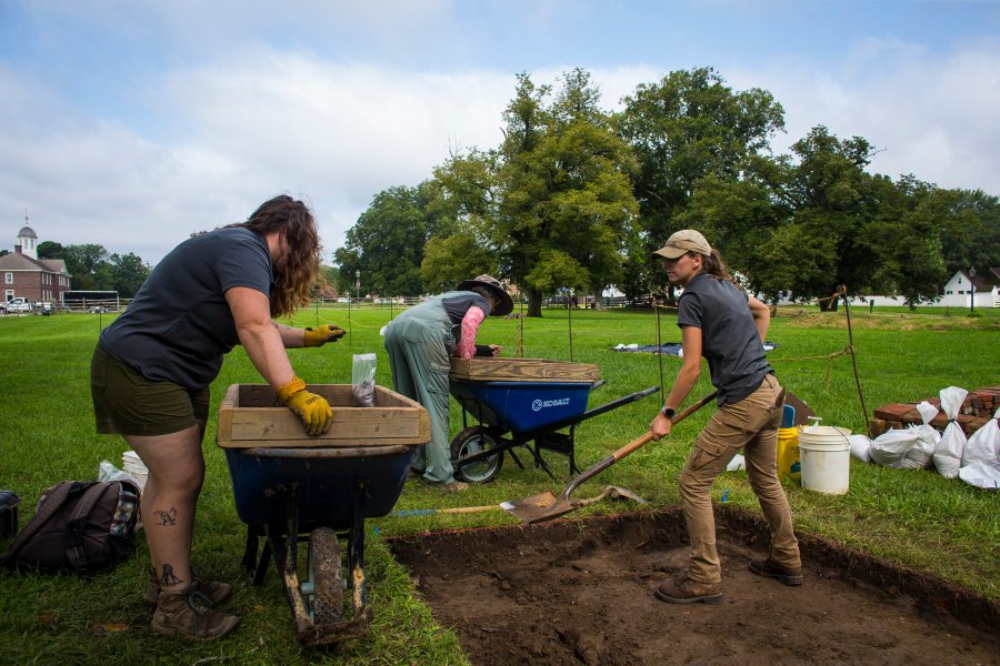 Colonial Williamsburg archaeologists Jennifer McGee, Megan Veness and Rachel Fisher look for possible artifacts at the former site of an 18th Century ornamental garden on Wednesday, July 31, 2024, in Williamsburg, Va. (AP Photo/John C. Clark)