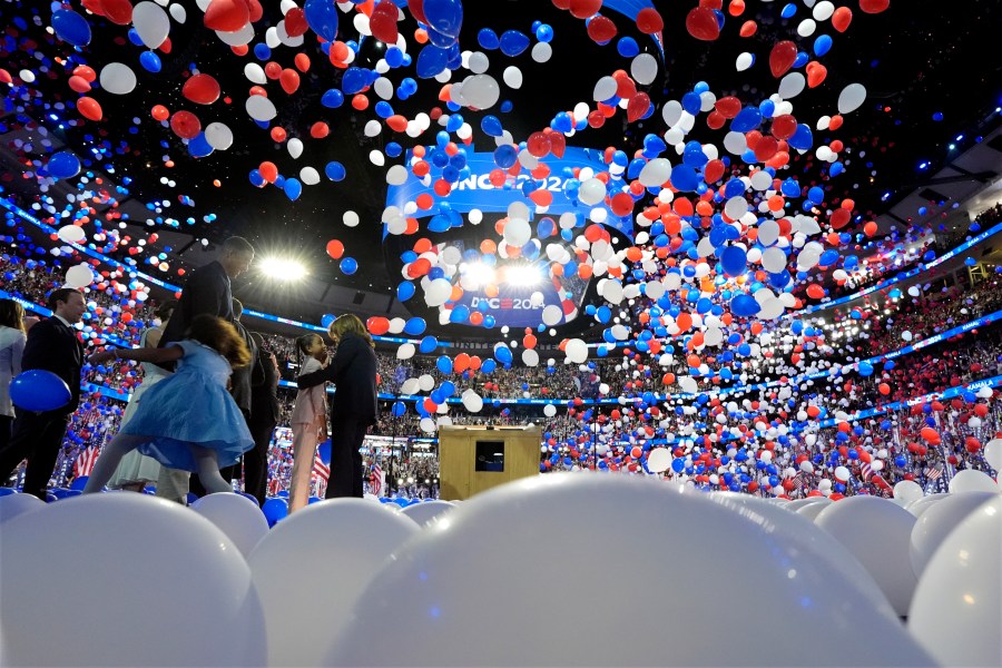 Democratic presidential nominee Vice President Kamala Harris, second gentleman Doug Emhoff, Democratic vice presidential candidate Minnesota Gov. Tim Walz and his wife Gwen Walz and members of their families stand on stage as balloons drop on the final night of the Democratic National Convention in Chicago, Thursday, Aug. 22, 2024. (Kent Nishimura/The New York Times via AP, Pool)