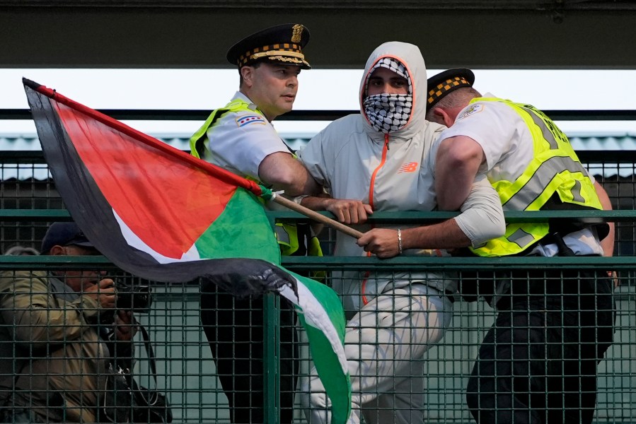 Police detain a protester during a demonstration outside the Democratic National Convention Wednesday, Aug. 21, 2024, in Chicago. (AP Photo/Alex Brandon)