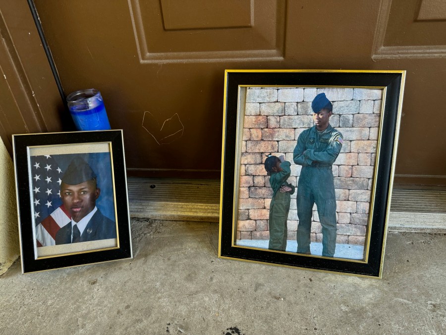 Candles and framed photos of Roger Fortson, a U.S. Air Force senior airman who was fatally shot by a Fla. sheriff's deputy on May 3, 2024, sit on Friday, Aug. 23, in the doorway of the apartment where he was killed in Fort Walton Beach, Fla. (AP Photo/Kate Payne)