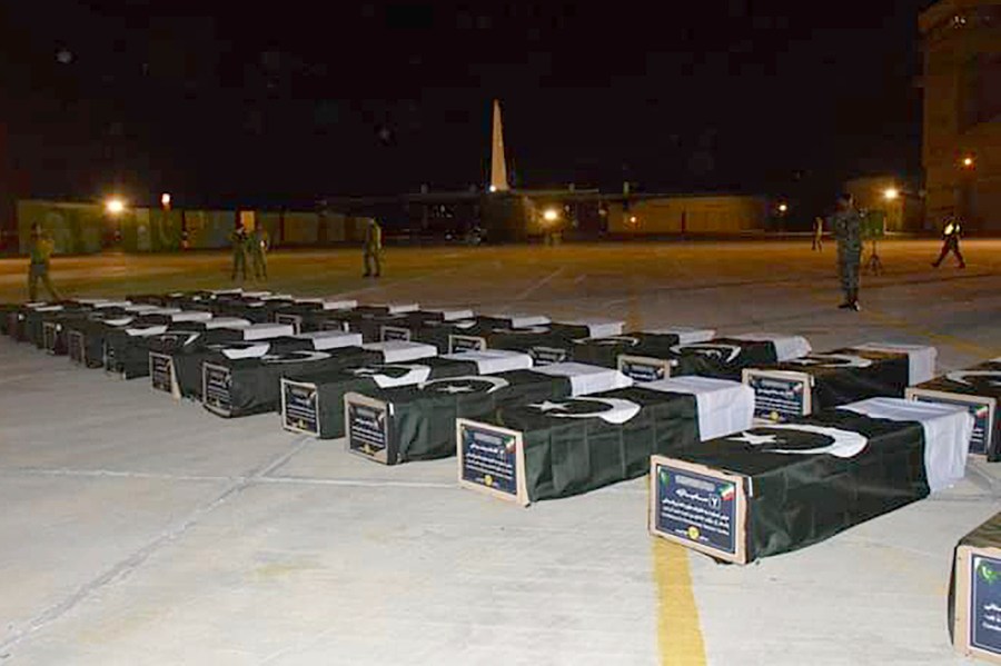 In this photo released by the Pakistan Air Force, bodies of Shiite Muslim pilgrims who were killed in a bus crash in Iran while heading to Iraq for a pilgrimage, arrive at an airbase in Jacobabad, Pakistan, Saturday, Aug. 24, 2024. (Pakistan Air Force via AP)